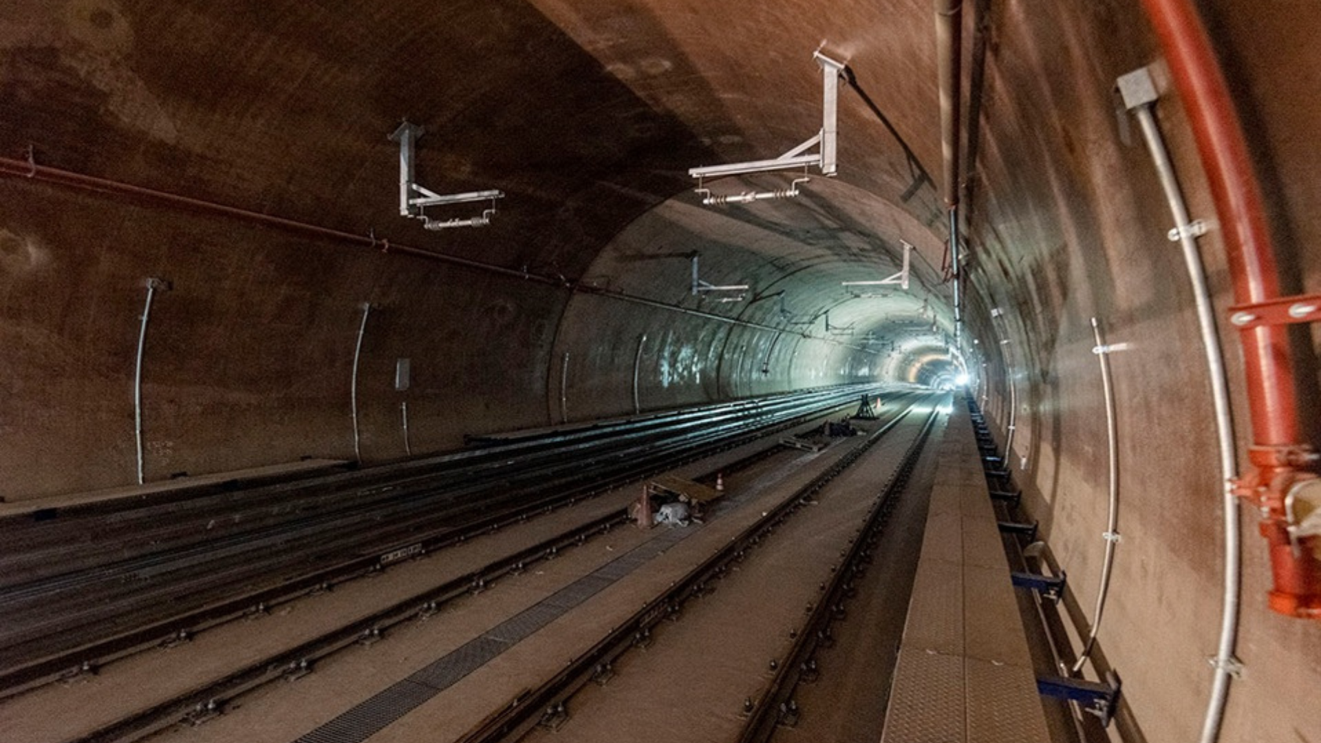 Rail tunnel interior with tracks, utilities and safety systems